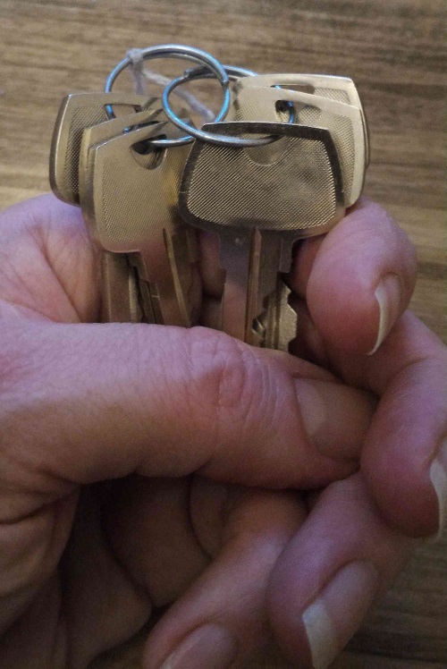 Hand holding a set of keys.