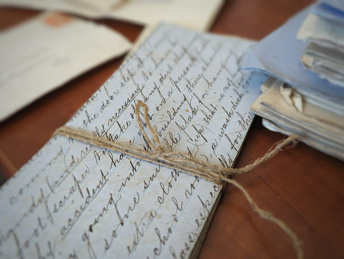 Bundle of handwritten papers tied with string.