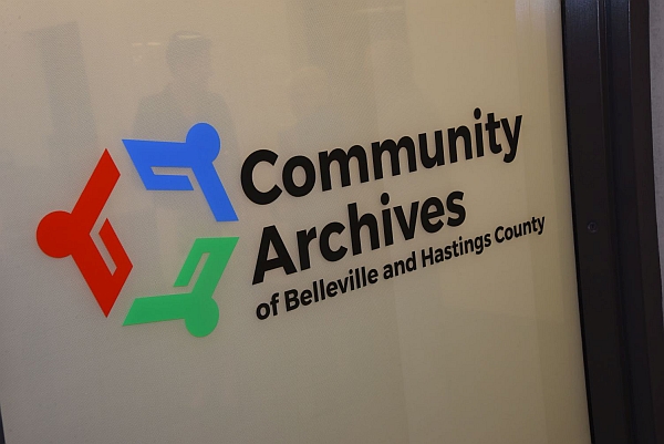 Window with Community Archives logo.