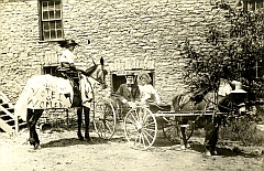 People with horse and cart and Votes for Women sign.