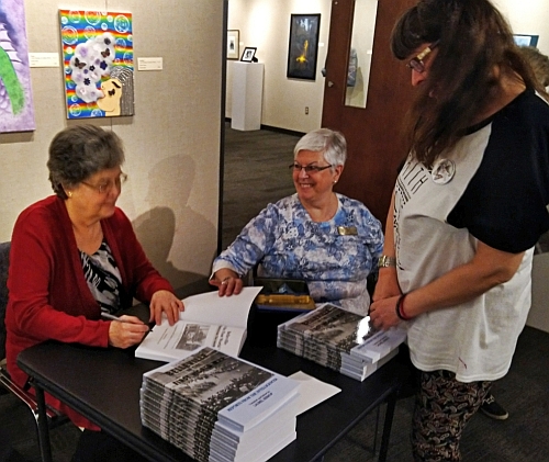 Laurel Bishop signing copies of her book.