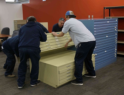 Men installing map chests.