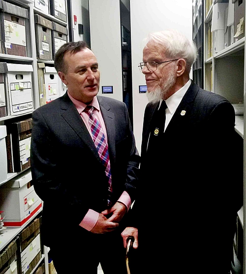 MP Neil Ellis and Gerry Boyce between shelves of records.