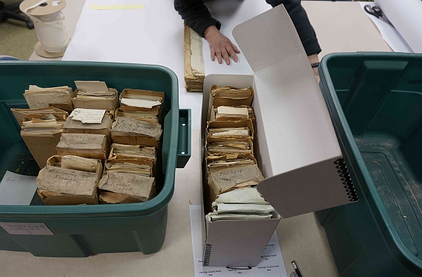 Archival materials being placed in acid-free containers.