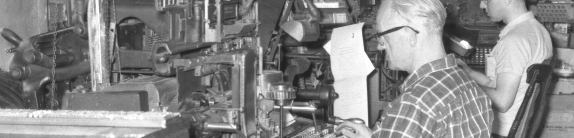 Men working in the print room of a newspaper office.