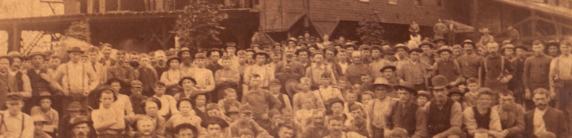 Group of people in front of a sawmill