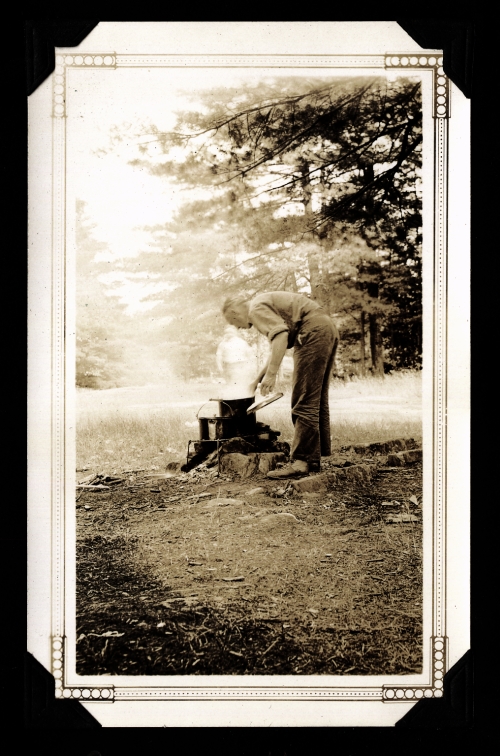 Ralph cooking over a fire.