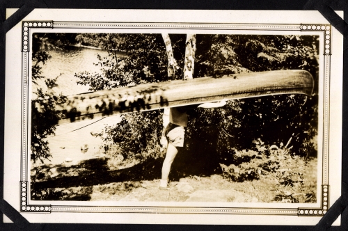 Ralph portaging a canoe.