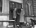 Two men standing outside a building.