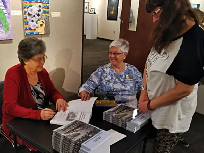 Laurel Bishop signing copies of her book.