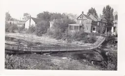 Footbridge collapsed on the river bed.
