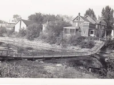 Footbridge collapsed on the river bed.