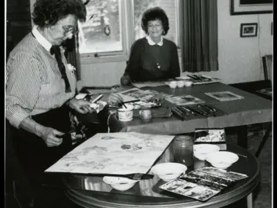 Two women sitting at a table.