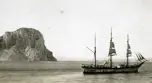 Sailing ship by a cliff.