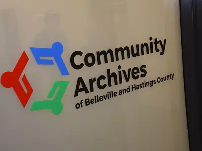 Front window of Community Archives of Belleville and Hastings County, with logo.