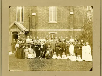 Group of people in front of a church building.