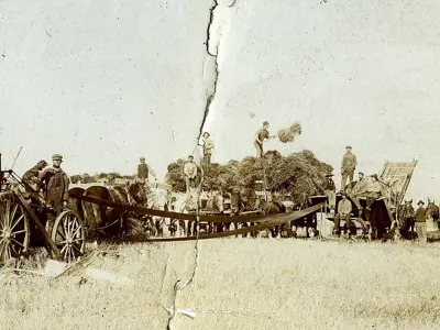 Threshing machine and farm workers.