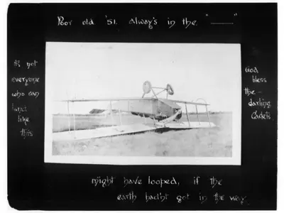 Photograph of upside-down First World War aircraft on the ground.