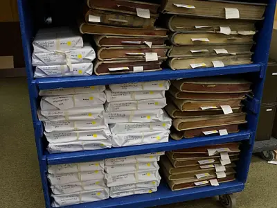 Computer cart full of volumes.