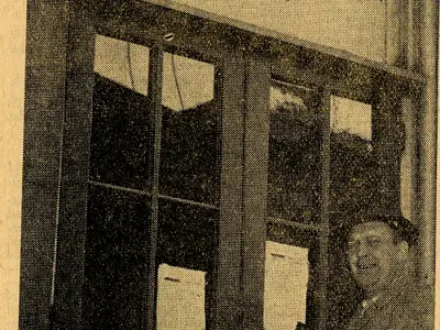 Man standing outside Post Office door.