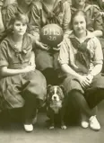 Detail of a sports team photo with a dog.