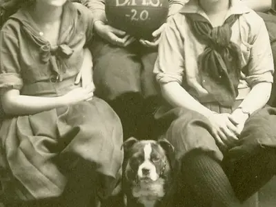Detail of a sports team photo with a dog.