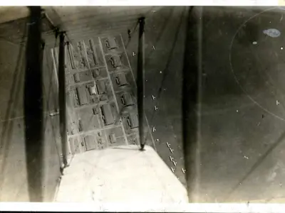 View of an airfield taken looking down through the wings of a biplane.