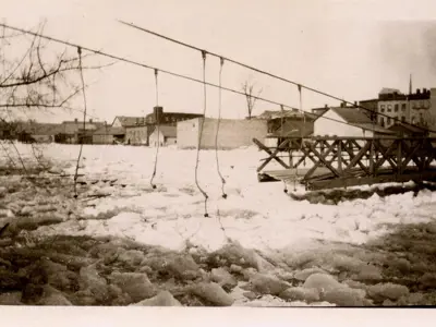 Footbridge damaged by ice on the river.