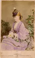 Hand-tinted photograph of a woman.